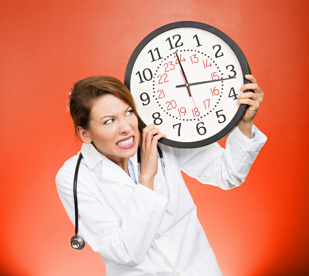 Closeup portrait, overwhelmed, busy unhappy stressed female health care professional, funny looking doctor holding big clock running out of time exhausted, isolated red background. Healthcare reform